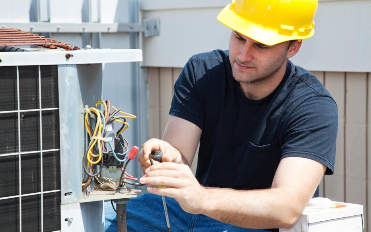 Preferred service technician repairing HVAC system