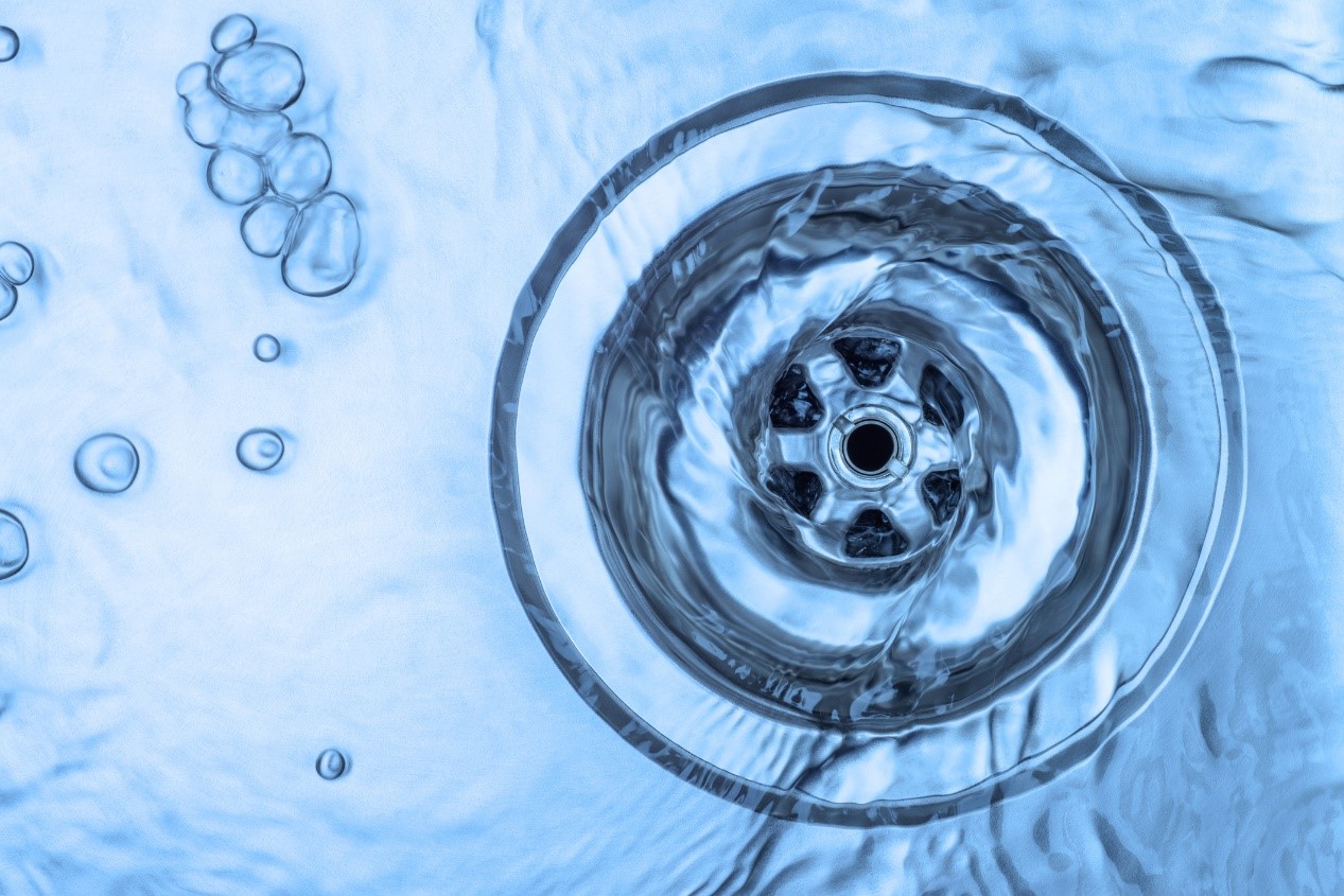 Close up image of water circling a drain
