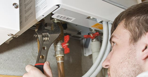 Water Heater technician working on Tankless Water Heater 