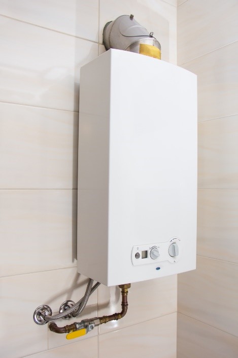 Tankless water heater attached to a wall