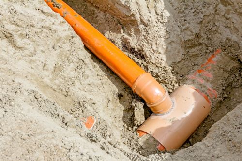Exposed orange main water line pipe