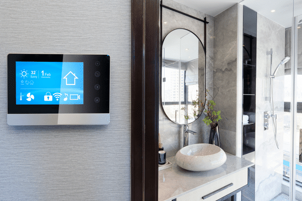 Image of a smart thermostat against the backdrop of a nice bathroom