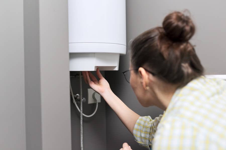 woman checking on water heater