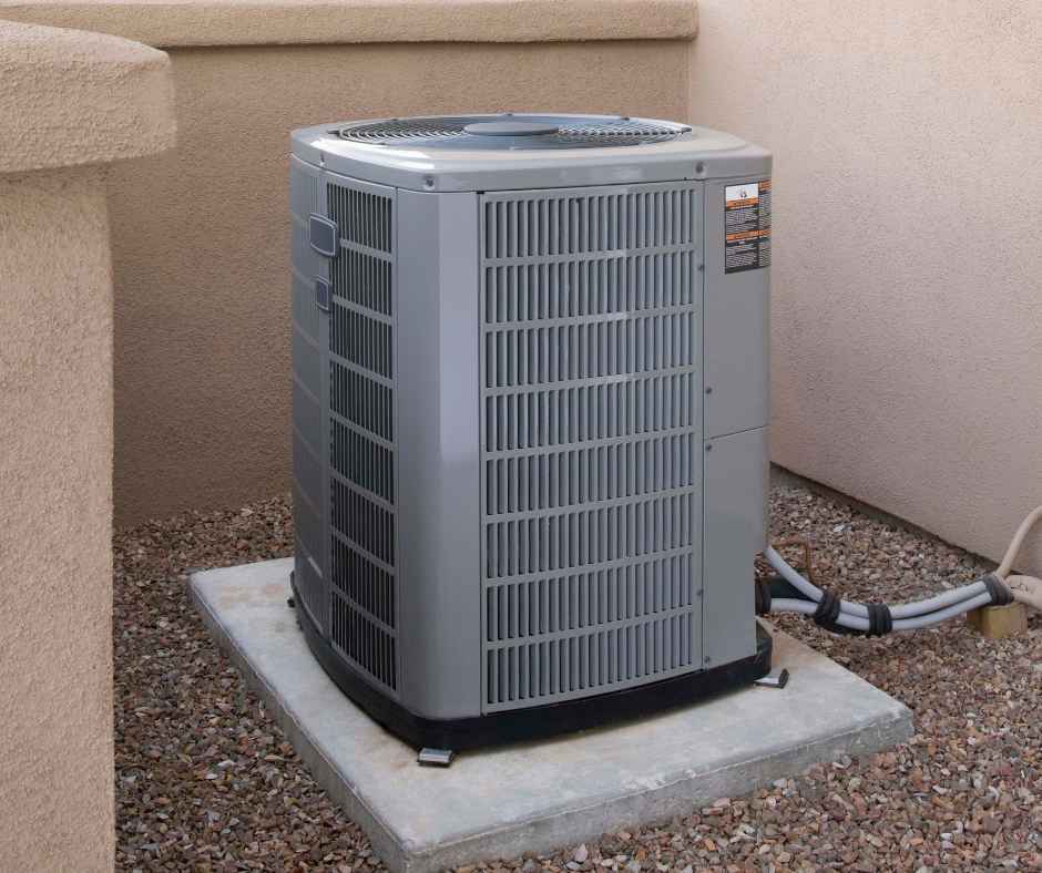 Air conditioner outside a home on a slab of concrete