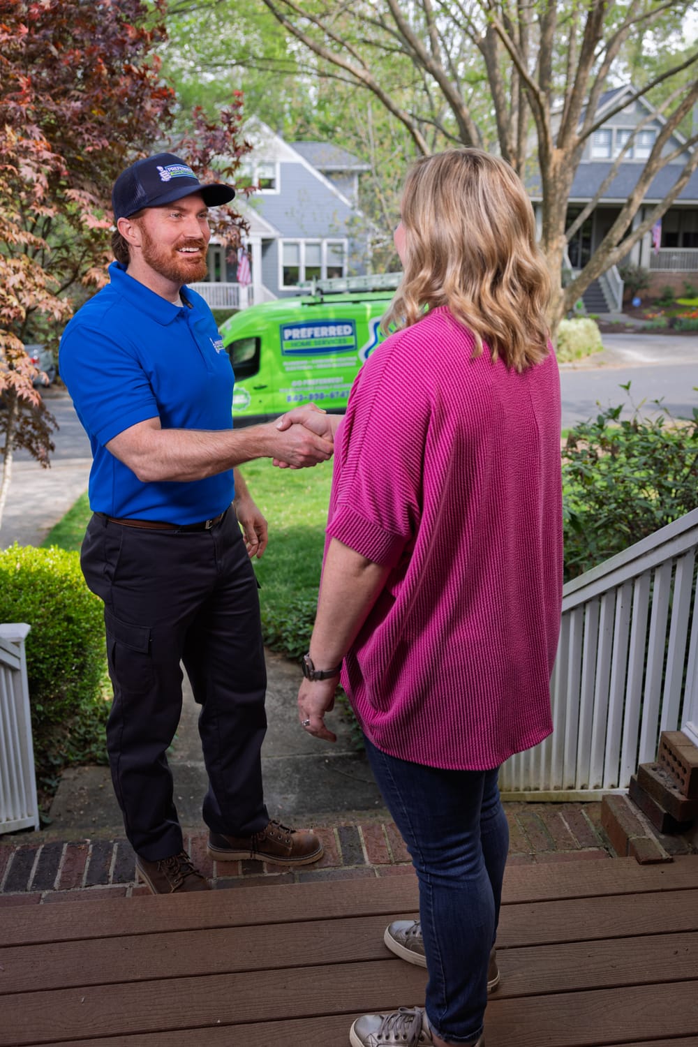 A professional Preferred Home Services technician and a satisfied homeowner shake hands after a successful emergency plumbing service restoration in the South Carolina.