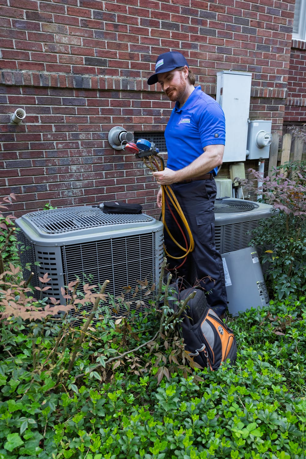 A Preferred Home Services specialist performs a thorough safety check and heating repair on a residential HVAC unit to ensure efficient performance and home warmth.