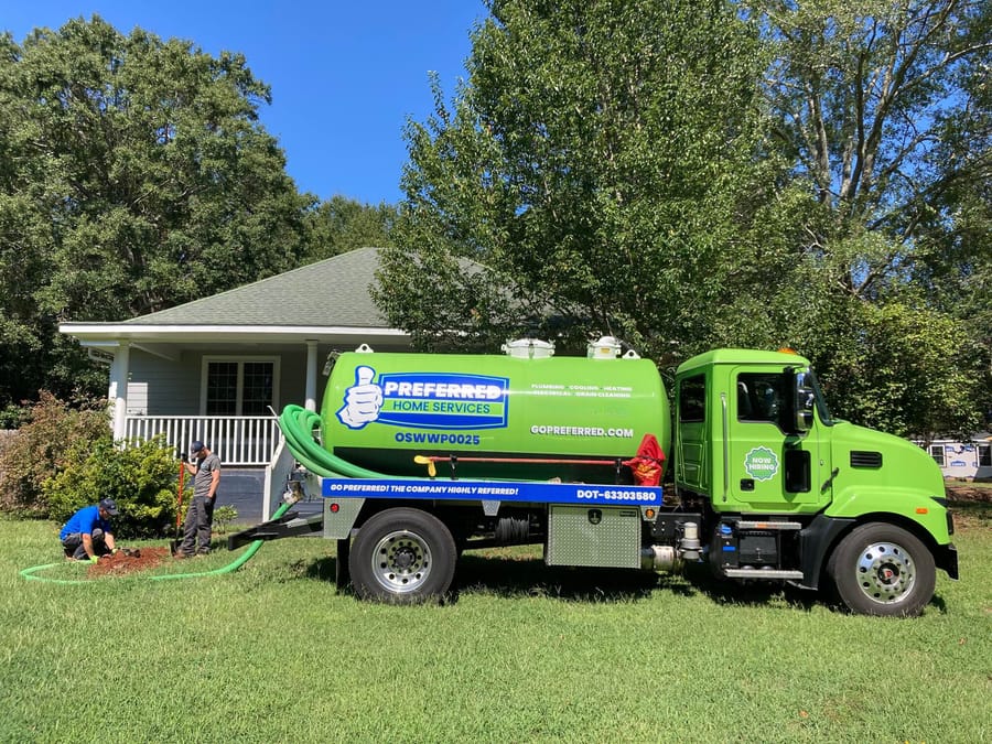 A Preferred Home Services master plumber arrives at a South Carolina home to perform a professional sewer camera inspection, monitoring a digital screen to locate a pipe blockage.