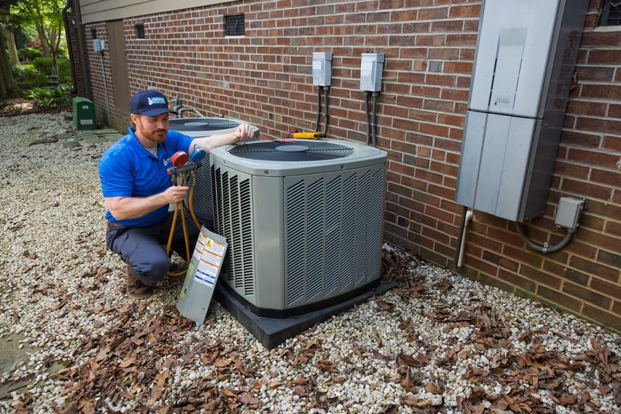 Licensed HVAC technician servicing a residential air conditioning system in South Carolina.