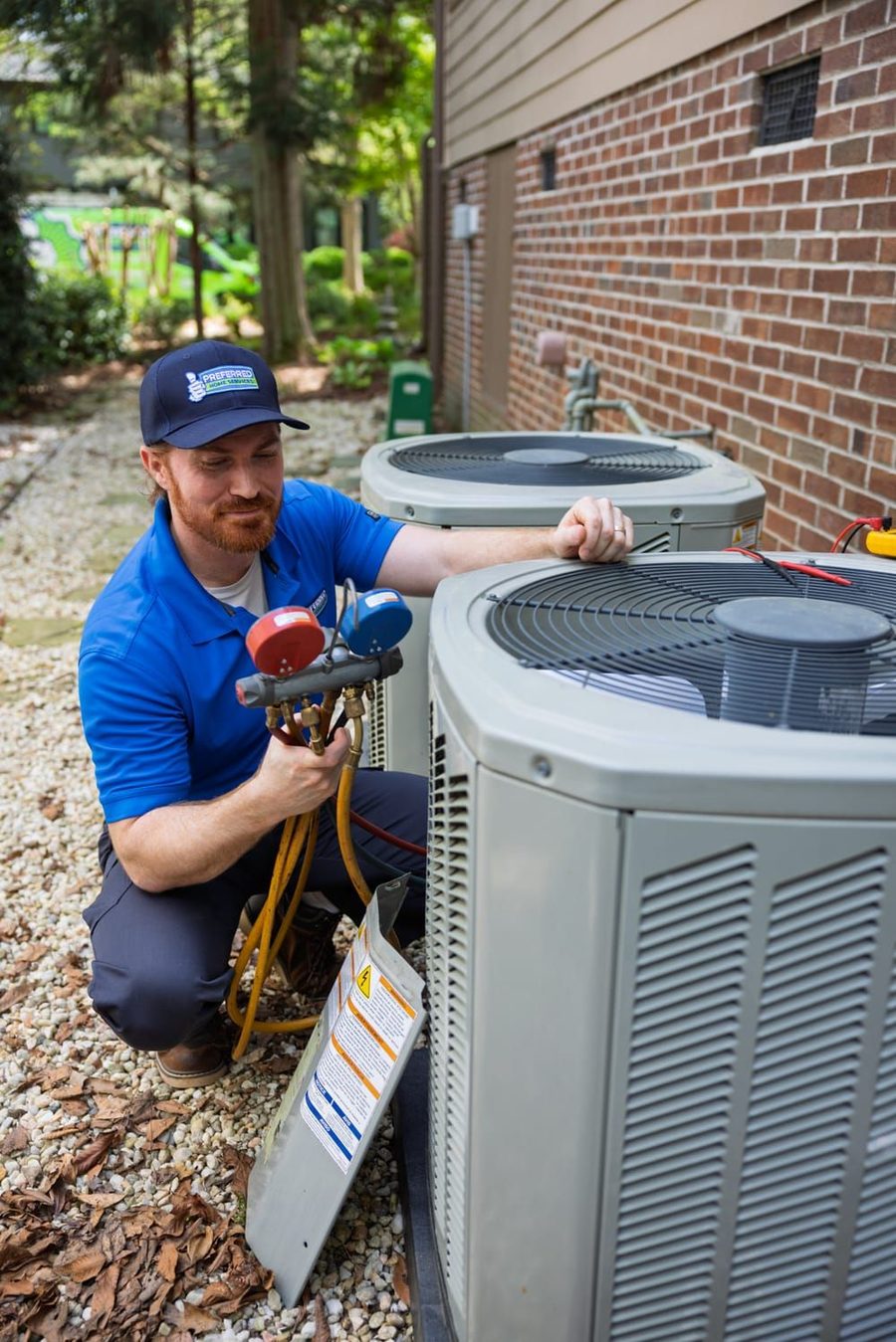 A Preferred Home Services specialist performs a detailed technical calibration on an outdoor unit to ensure peak efficiency during a professional heating services appointment.